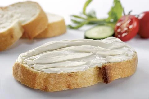 Slice of bread with cream cheese (selective focus) Stock Photos