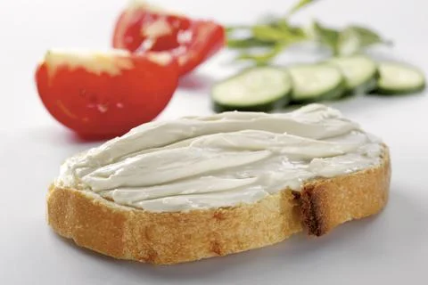 Slice of bread with cream cheese (selective focus) Stock Photos