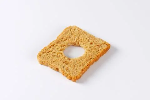 Slice of bread with cut out circle shape Stock Photos