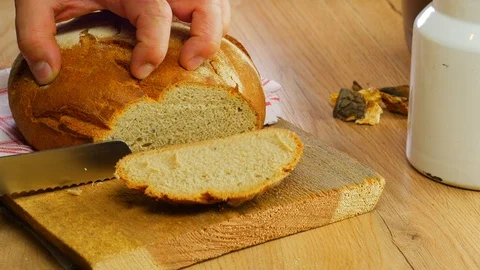 Slice of bread cut on a wood Stockbeeldmateriaal 108090795