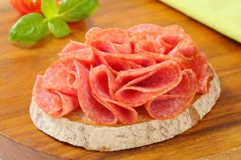 Slice of bread with dry salami Foto stock