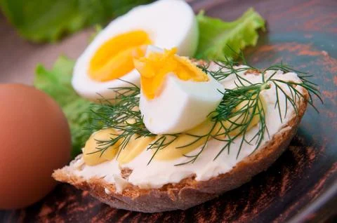 Slice of bread with mustard and cheese sauce and egg Stock Photos