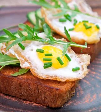 Slice of bread with mustard and cheese sauce and egg Stock Photos