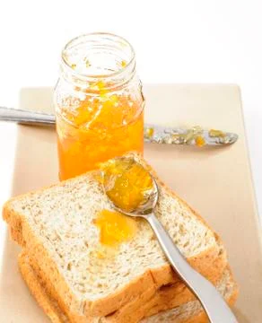 Slice of bread with orange jam Stock Photos