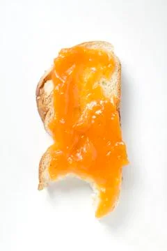 Slice of bread plait with apricot jam, a bite taken Foto stock