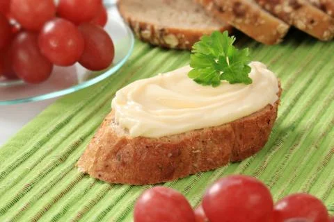 Slice of bread roll and creamy cheese spread Stock Photos