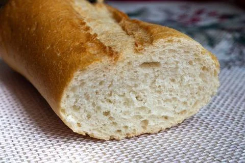 A slice of bread is shown with the crust removed Stock Photos