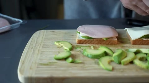 A slice of bread with a slice of cheese and a slice of avocado on top 스톡 동영상 299691411