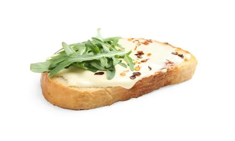 Slice of bread with spread and arugula on white background Stock Photos