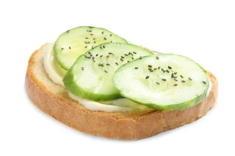 Slice of bread with spread and cucumber on white background Stock Photos