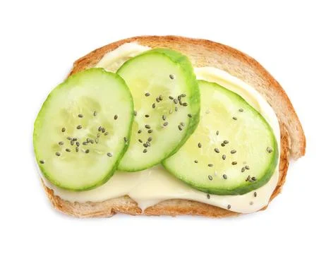 Slice of bread with spread and cucumber on white background, top view Stock Photos