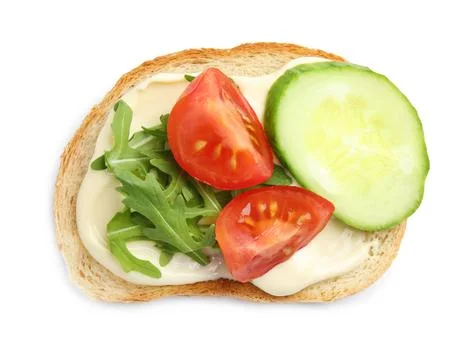 Slice of bread with spread and vegetables on white background, top view Stock Photos