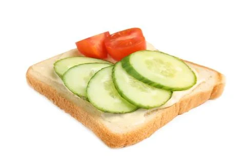 Slice of bread with spread and vegetables on white background Stock Photos