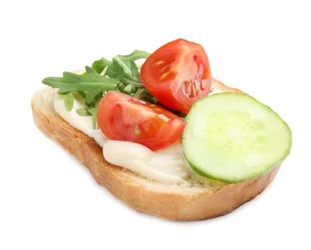 Slice of bread with spread and vegetables on white background Stock Photos