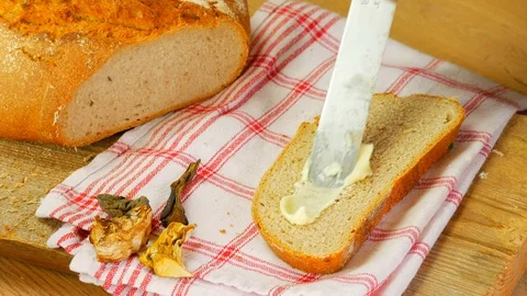 Slice of bread spred with butter Stockbeeldmateriaal 108090960