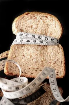 Slice of bread surrounded by a measurement tape Stock Photos