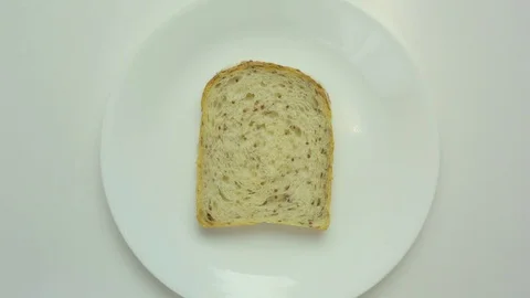 Slice of bread in a white plate Stock Footage 76103091