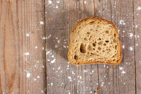 Slice of bread on wooden background Stock Photos