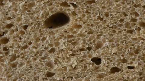 A slice of brown bread, up close 스톡 동영상 102138402