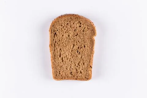 Slice of brown bread on white background Stock Photos