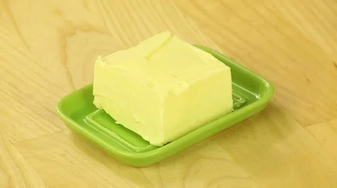 Slice butter in a green oiler Stock Footage 42952596