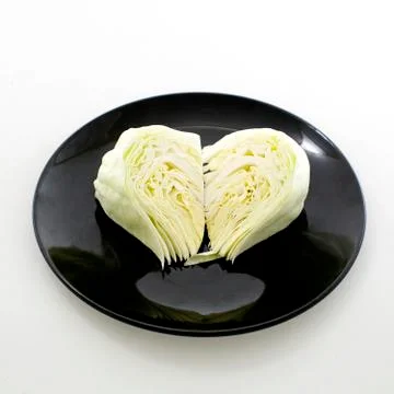Slice cabbage on black plate isolated on white background Stock Photos