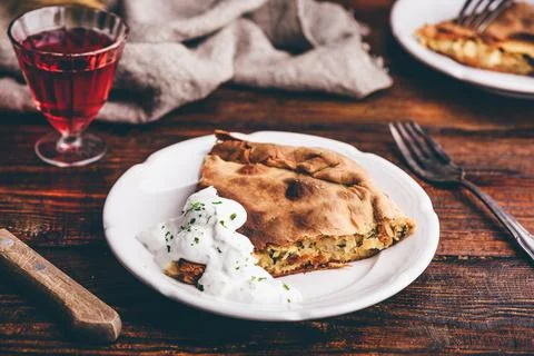 Slice of cabbage pie with sour cream sauce Stock Photos