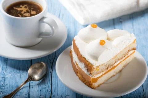 Slice of cake with coffee on a blue background Stock Photos