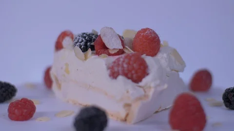 Slice of Cake Rotating over white background. Cake, berries Video stock 128081498