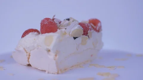 Slice of Cake Spinning over white background. Cake, Berries Stock-Footage 128083658