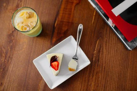 A slice of cake with strawberry. Ice cold coffee. Stock Photos