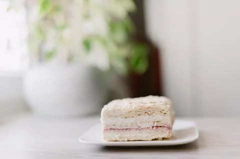 A slice of cake is on a white plate Stock Photos