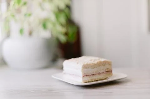 A slice of cake is on a white plate Stock Photos