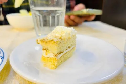 A slice of cake on a white plate. Stock Photos