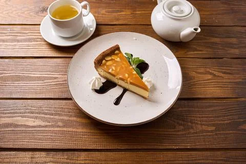 Slice of Caramel Cheesecake with Tea Stock Photos