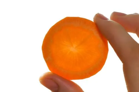 Slice of carrot in hand, close up shoot Stock Photos