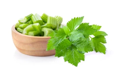 Slice celery in wood bowl isolated on white background Stock Photos