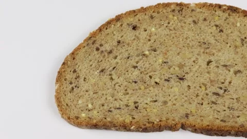 Slice of cereal bread isolated on a white background Stock Footage 259189632