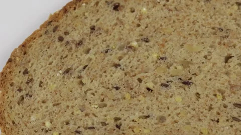 Slice of cereal bread isolated on a white background Stock Footage 259189660