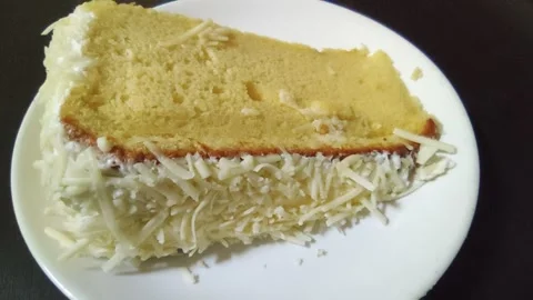 A slice of cheddar cheese cream cake Stock Footage 261154877