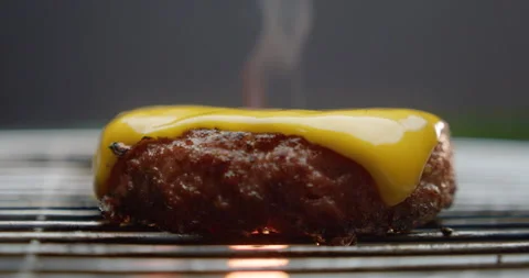 A slice of cheese on a burger patty 스톡 동영상 310957944