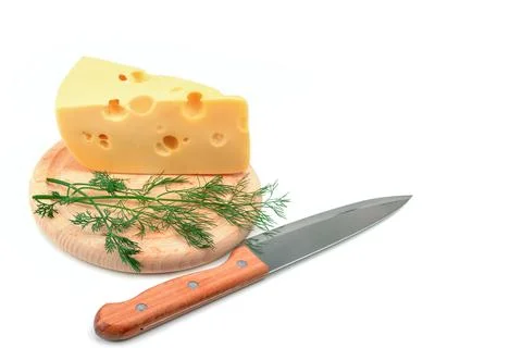 A slice of cheese on a kitchen board isolated on white background. Free space Stock Photos