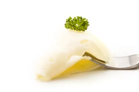 Slice of cheese with parsley on fork Foto stock