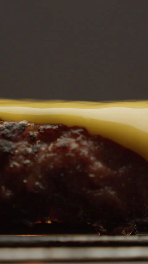 Slice of cheese on a patty vertical video 스톡 동영상 310955875