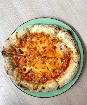 Slice of cheese pizza on plate. close up. Stock Photos