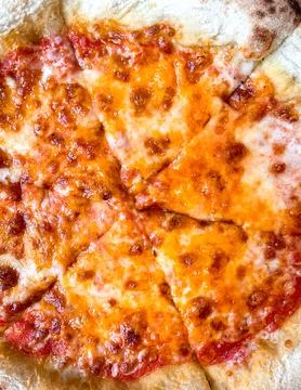 Slice of cheese pizza on plate. close up. Stock Photos
