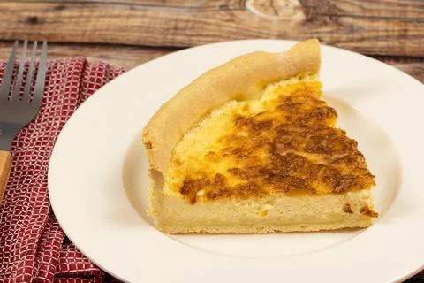 Slice of cheese tart (comté), close-up, on a plate Stock Photos