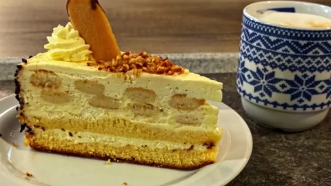 Slice of Cheesecake with Coffee Cup Stock Footage 335393876