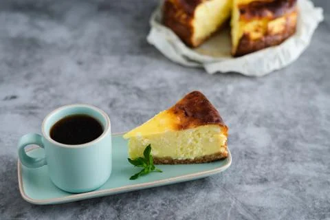 Slice of cheesecake with a cup of coffee. Copy space. Stock Photos