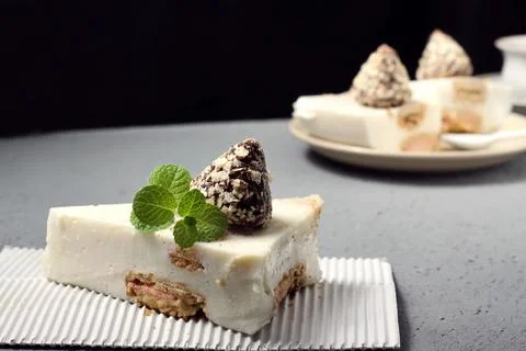 Slice of cheesecake on a gray background,fragrant sprig of mint Stock-Fotos